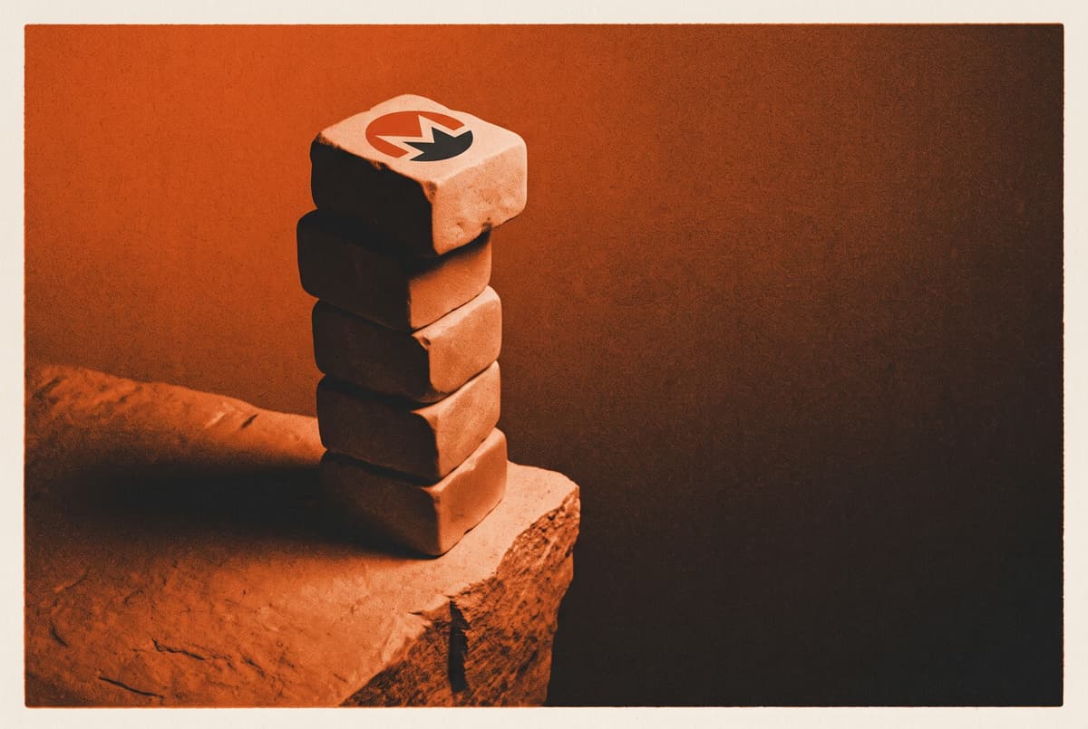 A tall stack of blocks marked with the Monero logo teeters on the edge of a narrow ledge above a dark drop.