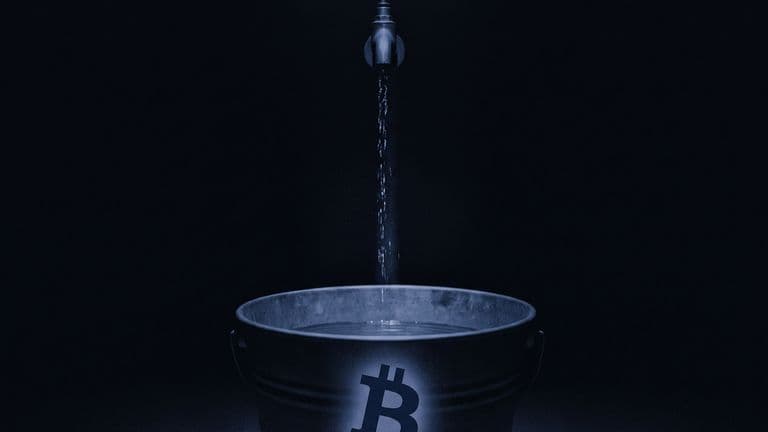 A thin stream of water falls from a tap into a large bucket marked with the Bitcoin symbol that holds only a little water at the bottom.