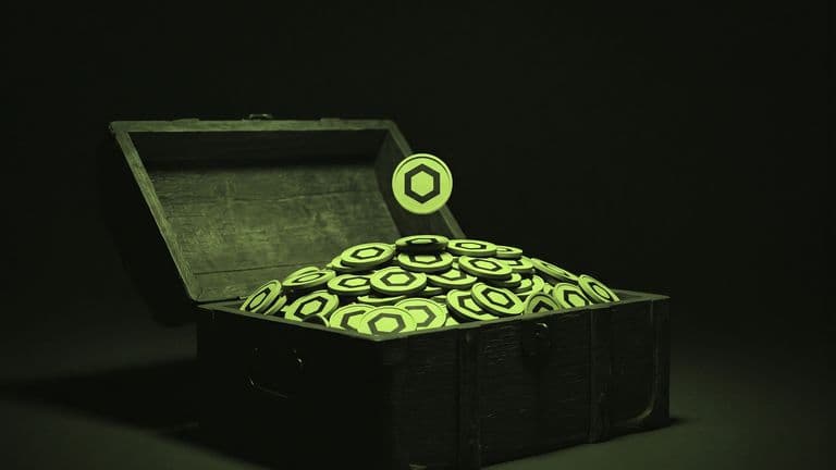 An open wooden chest piled high with coins bearing the Chainlink mark, with one more coin falling onto the heap against a dark background.
