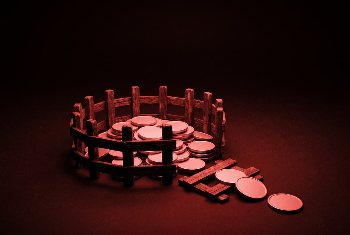 A pile of plain coins inside a small round wooden fence that has one panel knocked flat, with a few coins rolling out through the gap.