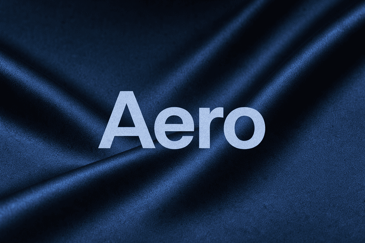 The word Aero in large pale letters centred over two dark, blurred folds of silk that flow in from opposite sides and merge into one.