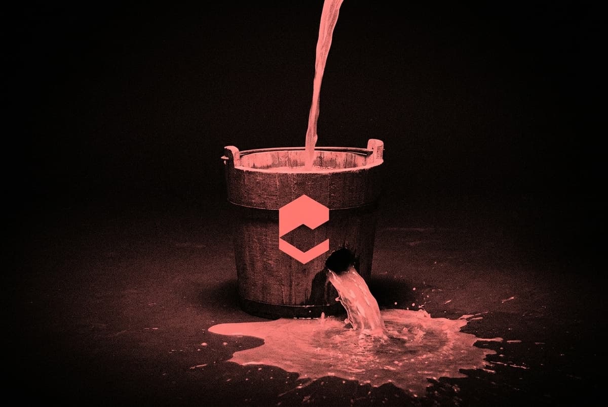 A wooden bucket with a large hole in its base as a stream pours in from above and gushes straight back out onto the floor, leaving only a little inside.