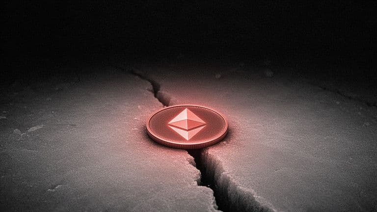 A coin with the Ethereum mark lies on a sheet of ice as a single crack spreads out from underneath it into the dark.